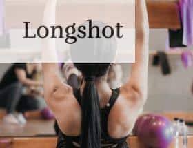woman in black tank top and black shorts doing yoga