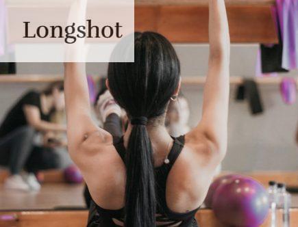 woman in black tank top and black shorts doing yoga