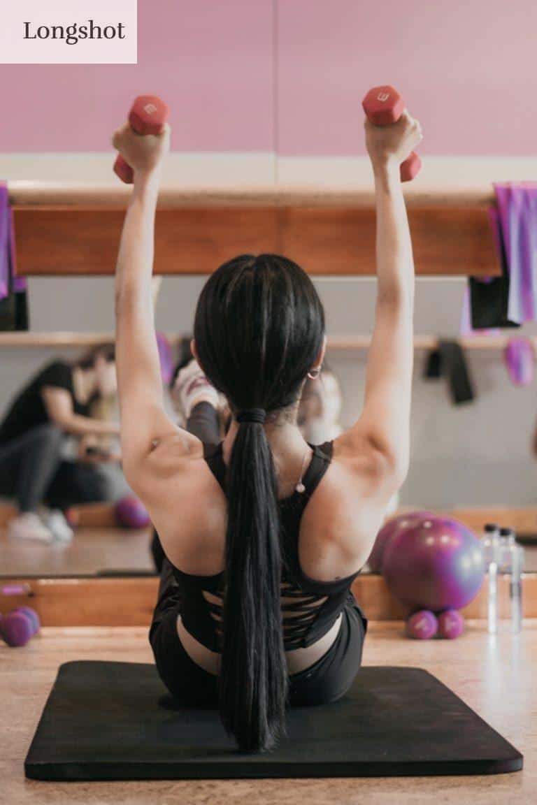 woman in black tank top and black shorts doing yoga