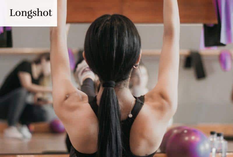 woman in black tank top and black shorts doing yoga