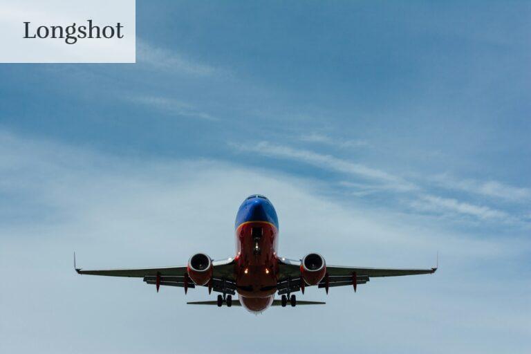 blue and red airplane on sky