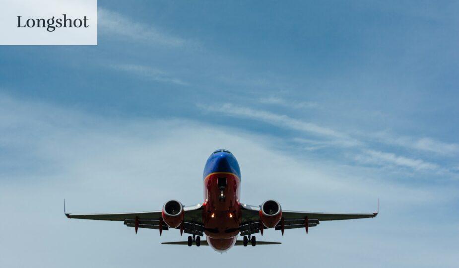 blue and red airplane on sky