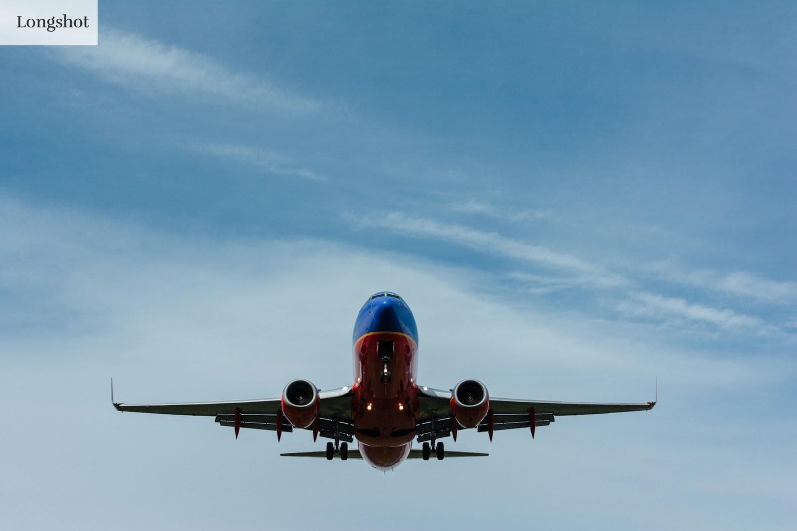 blue and red airplane on sky