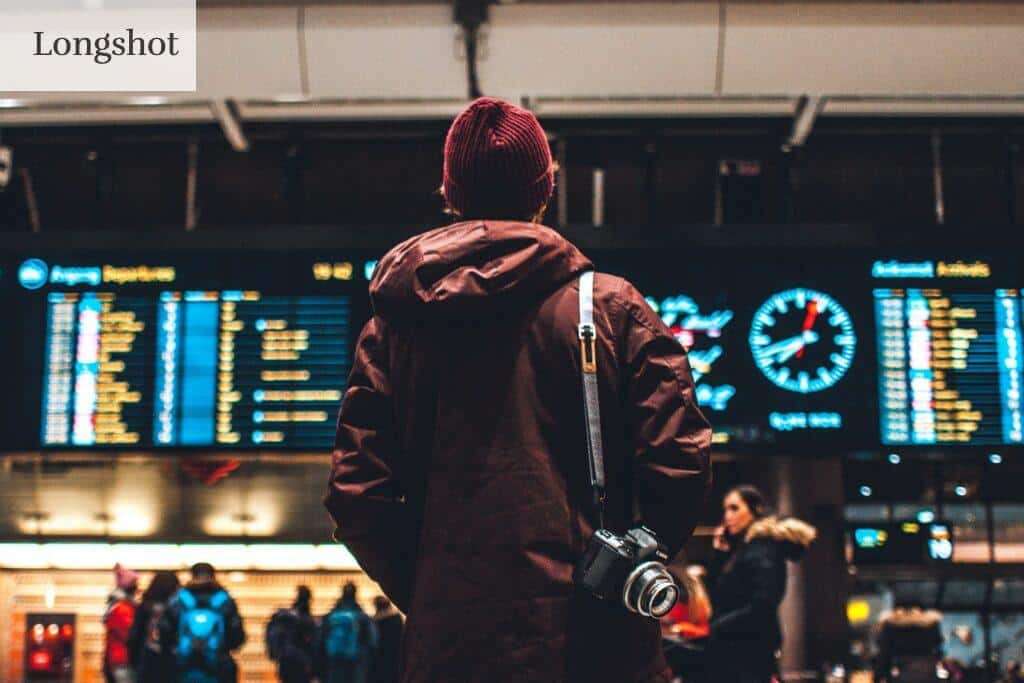 person looking up to the flight schedules