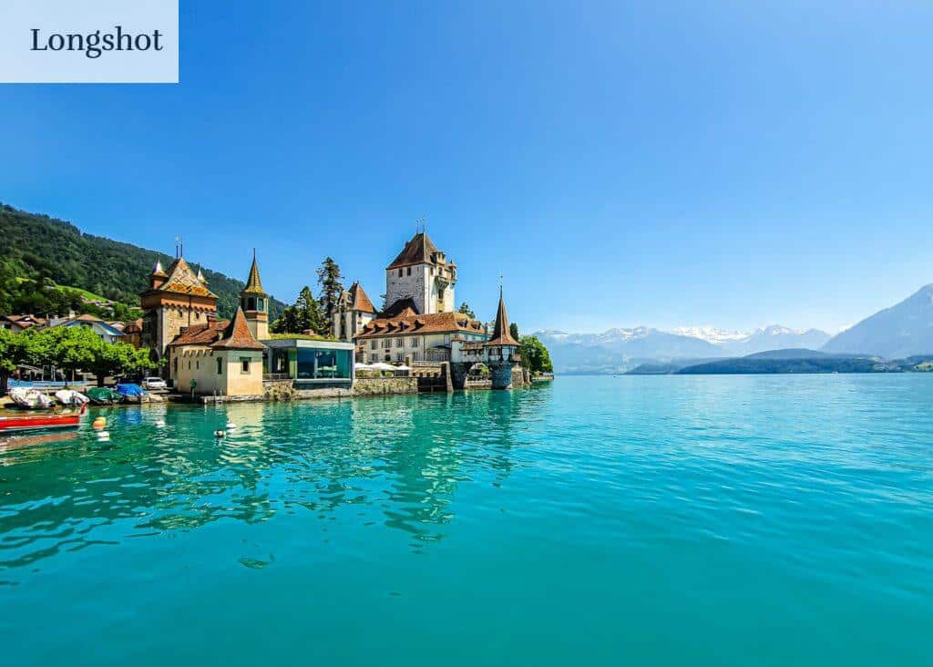 Experience the enchanting Oberhofen Castle on the turquoise shores of Lake Thun in Switzerland.