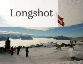 Majestic snowy view from Rigi Kulm, Switzerland, with Swiss flag and mountains.