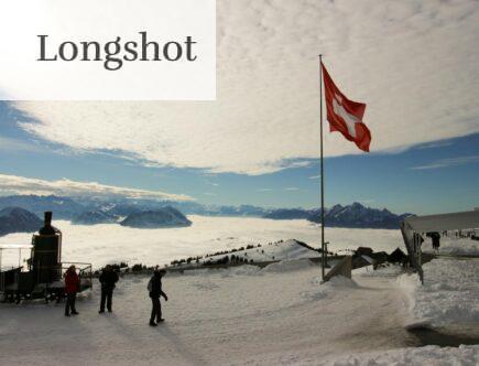 Majestic snowy view from Rigi Kulm, Switzerland, with Swiss flag and mountains.