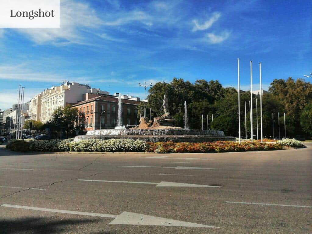 a large building with a fountain in the middle of it