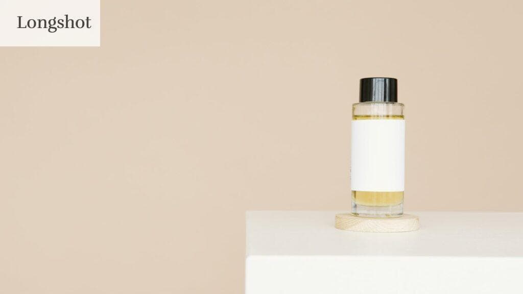 A sleek cosmetic bottle with blank label on a clean white platform against a neutral background.