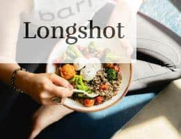 a woman is holding a bowl of food