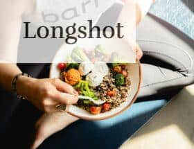 a woman is holding a bowl of food