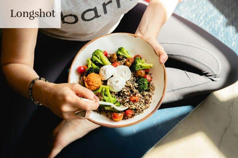 a woman is holding a bowl of food