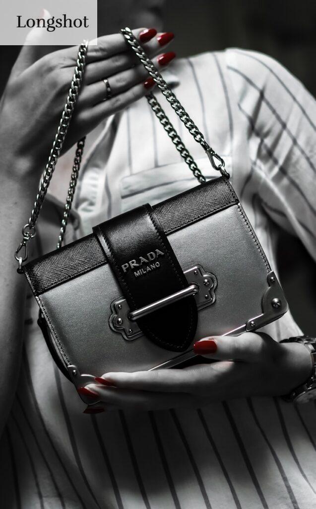 black leather handbag on white textile