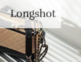 brown and black leather sling bag