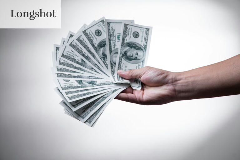 person holding 100 US Dollar banknote