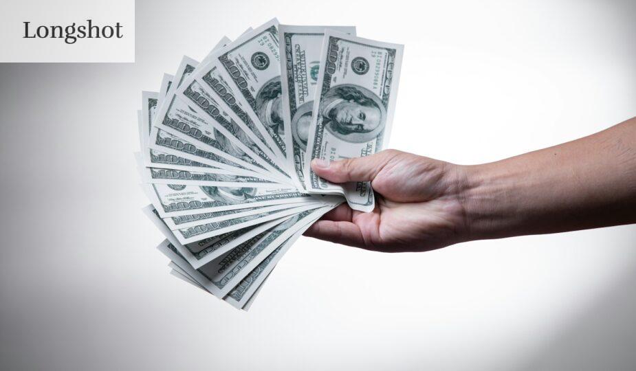 person holding 100 US Dollar banknote