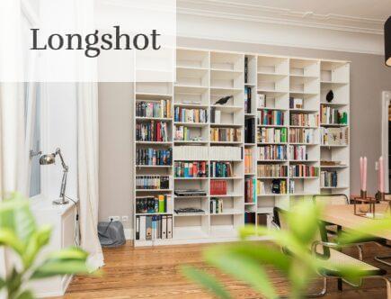 white wooden book shelves on brown wooden parquet floor