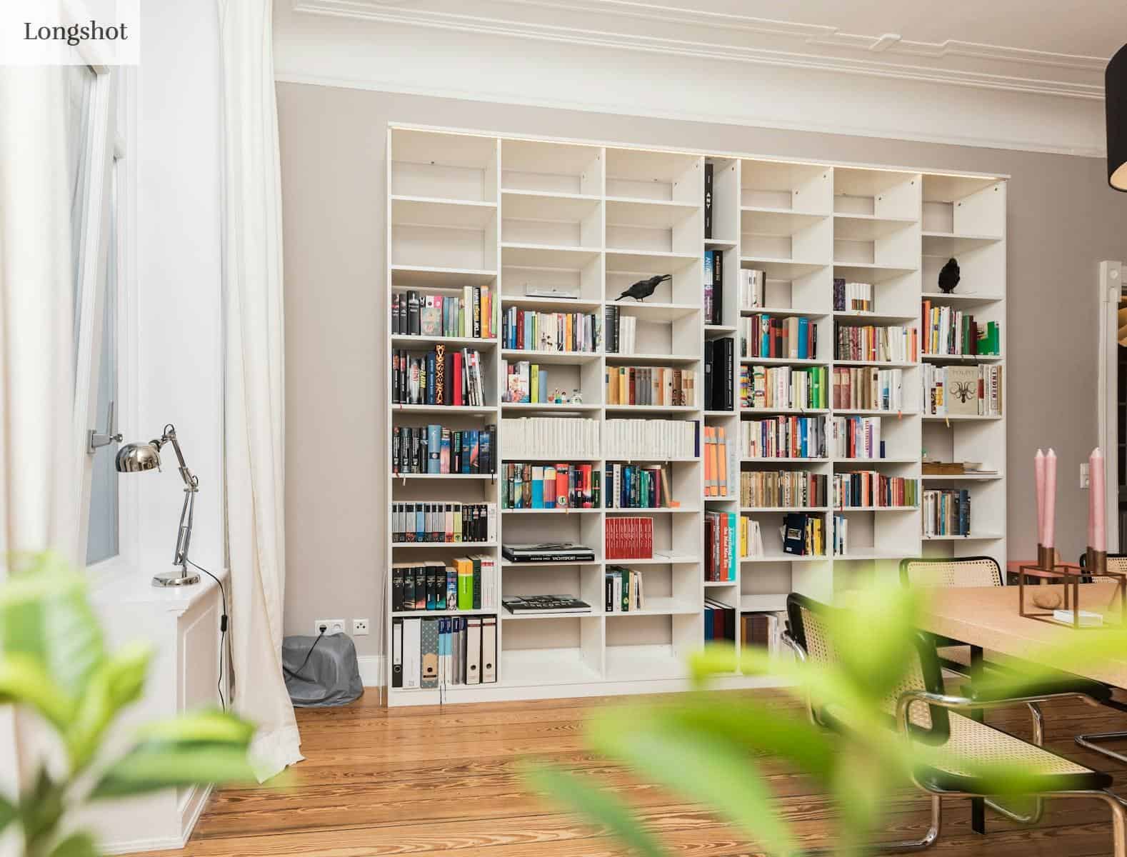 white wooden book shelves on brown wooden parquet floor